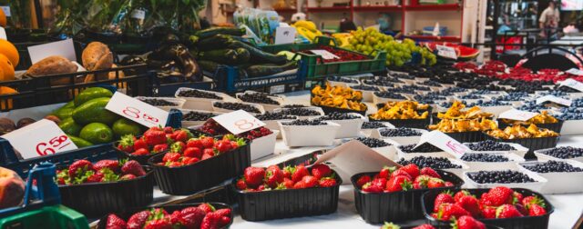 A bunch of fruits are on display at a market